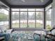 Sunroom with large windows, comfortable seating, and view of landscaped yard at 630 Deese Rd, Monroe, NC 28110