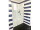 Coastal-themed bathroom featuring glass shower with shelves and a clean design at 637 Williamson Rd # 304, Mooresville, NC 28117