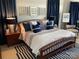 Nautical bedroom with beautiful wood frame bed and blue accents with carpeted floor at 637 Williamson Rd # 304, Mooresville, NC 28117