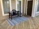 Inviting front porch with a cozy bench, rug, and decorative accents at 637 Williamson Rd # 304, Mooresville, NC 28117