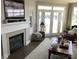 Cozy living room with fireplace, lake views, and comfortable furnishings at 637 Williamson Rd # 304, Mooresville, NC 28117