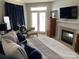 Cozy bedroom featuring a fireplace, TV, and patio access with blue and white decor at 637 Williamson Rd # 304, Mooresville, NC 28117