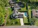 Expansive aerial view of a manicured property featuring a beautiful in-ground pool, and an elegant home at 6700 Folger Dr, Charlotte, NC 28270