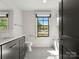 Bright bathroom with modern fixtures, black accents, and a view of the outdoors at 6700 Folger Dr, Charlotte, NC 28270