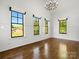 Bright, airy bedroom with large windows, hardwood floors, and custom light fixture at 6700 Folger Dr, Charlotte, NC 28270