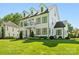 Elegant two-story home boasts a balcony, pristine lawn, mature landscaping, and classic design at 6700 Folger Dr, Charlotte, NC 28270