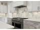 Updated kitchen featuring stainless steel appliances, stylish white cabinets and marble backsplash at 6700 Folger Dr, Charlotte, NC 28270