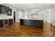 Stylish kitchen featuring a large island, custom cabinetry, stainless steel appliances, and modern lighting fixtures at 6700 Folger Dr, Charlotte, NC 28270