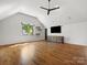 Large, modern living room with hardwood floors, vaulted ceiling, and plenty of natural light at 6700 Folger Dr, Charlotte, NC 28270