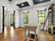 Office space with dark hardwood floors, natural light, and sleek black framed windows at 6700 Folger Dr, Charlotte, NC 28270