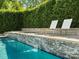 This stunning pool features a waterfall feature, and seating area to create the perfect oasis at 6700 Folger Dr, Charlotte, NC 28270