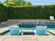 Inviting pool featuring seating and a serene water feature with lush landscaping at 6700 Folger Dr, Charlotte, NC 28270