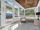 Cozy porch with wood ceiling, outdoor seating, and screened windows overlooking the lawn at 6700 Folger Dr, Charlotte, NC 28270
