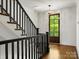 View of the staircase leading to a door with glass overlooking the trees at 6700 Folger Dr, Charlotte, NC 28270