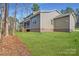 Lovely backyard with a screen porch, a lush lawn, and mature trees offering privacy at 7009 New Town Rd, Waxhaw, NC 28173