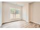 Comfortable bedroom with a large window offering natural light and wood-look floors and a white door at 7009 New Town Rd, Waxhaw, NC 28173