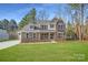 Charming two-story home featuring stone accents, a covered porch, and a well-manicured lawn at 7009 New Town Rd, Waxhaw, NC 28173
