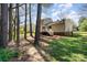 Back exterior of home featuring a wooden deck and yard with mature trees at 8224 Park Vista Cir, Charlotte, NC 28226
