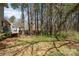 Home's backyard featuring a grassy area with tall trees at 8224 Park Vista Cir, Charlotte, NC 28226