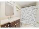 Bathroom with single vanity, toilet, and shower with patterned shower curtain at 8224 Park Vista Cir, Charlotte, NC 28226