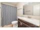 Bathroom with a dark vanity, toilet, and shower with patterned shower curtain at 8224 Park Vista Cir, Charlotte, NC 28226