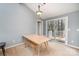 Bright dining room with a modern table, bench seating, and sliding glass doors at 8224 Park Vista Cir, Charlotte, NC 28226