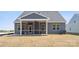 Rear view of home with a screened porch and a ceiling fan, overlooking the backyard at 896 Exeter Dr, Sherrills Ford, NC 28673