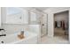 Modern bathroom boasts marble tile, a glass-enclosed shower, and a luxurious soaking tub with natural light at 896 Exeter Dr, Sherrills Ford, NC 28673