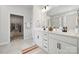 Bright bathroom featuring double vanity, sleek black fixtures, and a spacious walk-in closet for ample storage at 896 Exeter Dr, Sherrills Ford, NC 28673