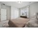 Bright bedroom featuring neutral decor, double closets, and a sunlit window for a serene living space at 896 Exeter Dr, Sherrills Ford, NC 28673