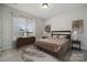 Inviting bedroom with neutral tones, ample natural light from large window, and stylish, modern furniture at 896 Exeter Dr, Sherrills Ford, NC 28673