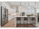 Modern kitchen featuring white cabinets, stainless steel appliances, and a large center island with bar seating at 896 Exeter Dr, Sherrills Ford, NC 28673