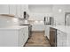 Modern kitchen featuring white cabinets, quartz countertops, and stainless steel appliances at 896 Exeter Dr, Sherrills Ford, NC 28673