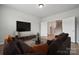 Cozy living room featuring a large sectional sofa, a modern TV, and staircase at 896 Exeter Dr, Sherrills Ford, NC 28673