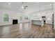 Open-concept living space with hardwood floors, fireplace, and a modern kitchen at 896 Exeter Dr, Sherrills Ford, NC 28673