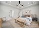 Main bedroom with tray ceilings, a ceiling fan, and bench at 896 Exeter Dr, Sherrills Ford, NC 28673