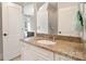 Bathroom vanity with granite countertop and white cabinets at 9011 Pine Laurel Dr, Weddington, NC 28104