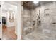 Walk-in shower features elegant tile work, a glass enclosure, and a built-in bench at 9011 Pine Laurel Dr, Weddington, NC 28104