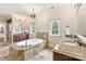 Luxurious bathroom with a soaking tub, dual vanities, and elegant finishes at 9011 Pine Laurel Dr, Weddington, NC 28104