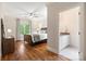 Stylish bedroom features hardwood floors, a ceiling fan, neutral paint, and an ensuite bathroom at 9011 Pine Laurel Dr, Weddington, NC 28104