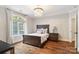 Bedroom with hardwood floors, a decorative chandelier, and an arched window at 9011 Pine Laurel Dr, Weddington, NC 28104