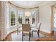 Sun-filled breakfast nook features a glass table with seating and many windows at 9011 Pine Laurel Dr, Weddington, NC 28104