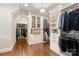 Spacious walk-in closet with custom shelving, hanging racks, and a crystal chandelier at 9011 Pine Laurel Dr, Weddington, NC 28104