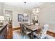 Dining room features hardwood floors, elegant lighting and view into kitchen at 9011 Pine Laurel Dr, Weddington, NC 28104