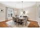Dining room features hardwood floors, elegant lighting and neutral colors at 9011 Pine Laurel Dr, Weddington, NC 28104