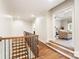 Second floor hallway featuring hardwood floors and an open view to the living room at 9011 Pine Laurel Dr, Weddington, NC 28104