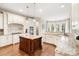 Bright kitchen features white cabinets, granite countertops, hardwood floors and a center island at 9011 Pine Laurel Dr, Weddington, NC 28104