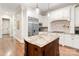 Modern kitchen with an island, stainless steel appliances, and white cabinetry at 9011 Pine Laurel Dr, Weddington, NC 28104