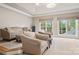 Comfortable living room boasts lots of natural light, neutral tones, plush seating, and a relaxing atmosphere at 9011 Pine Laurel Dr, Weddington, NC 28104