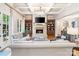 Spacious living room featuring a fireplace, hardwood floors, and coffered ceiling at 9011 Pine Laurel Dr, Weddington, NC 28104